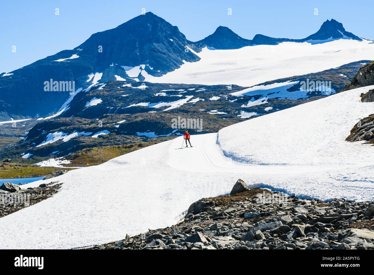Woman cross-country skiing in mountains Stock Photo