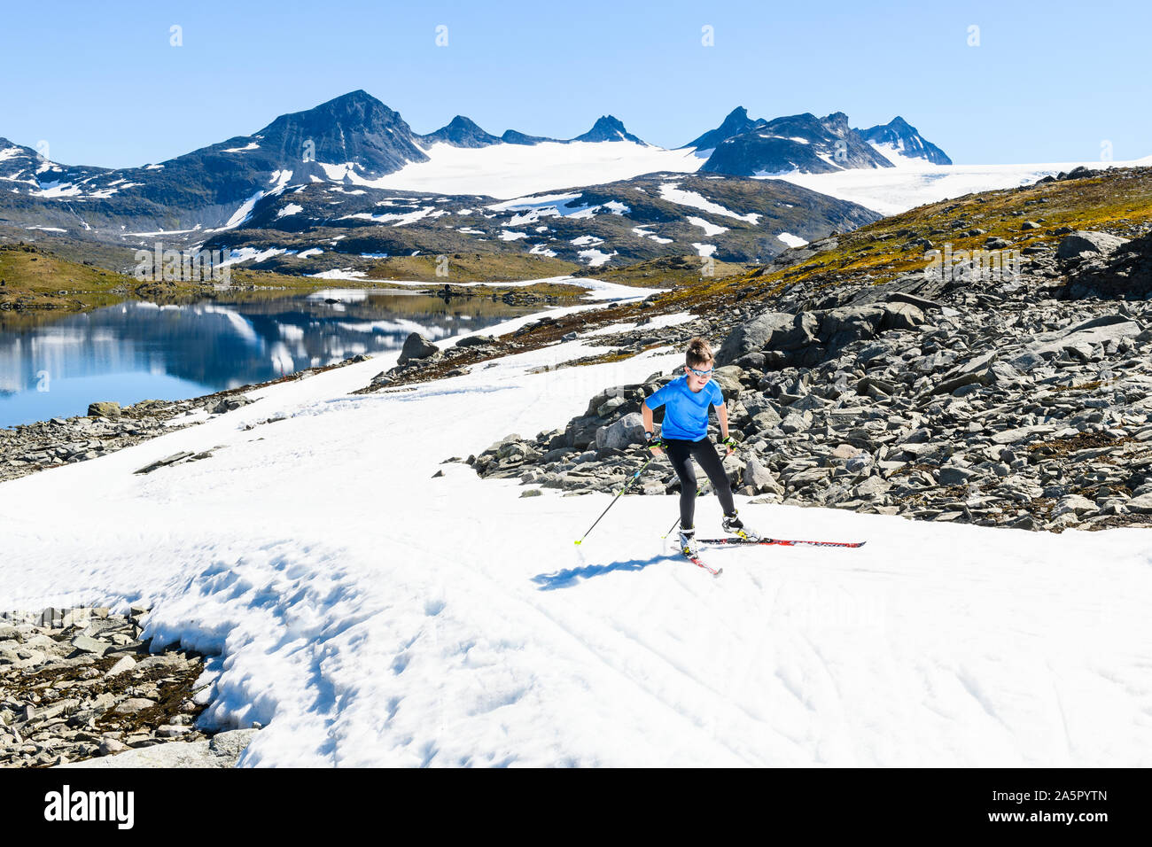 Boy cross-country skiing in mountains Stock Photo
