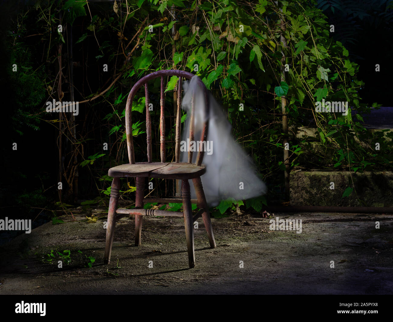 Old chair with cloth blowing in the breeze Stock Photo