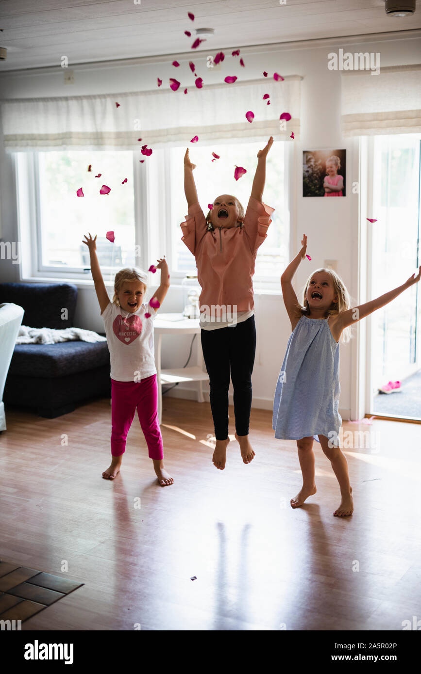 Happy girls throwing rose petals Stock Photo