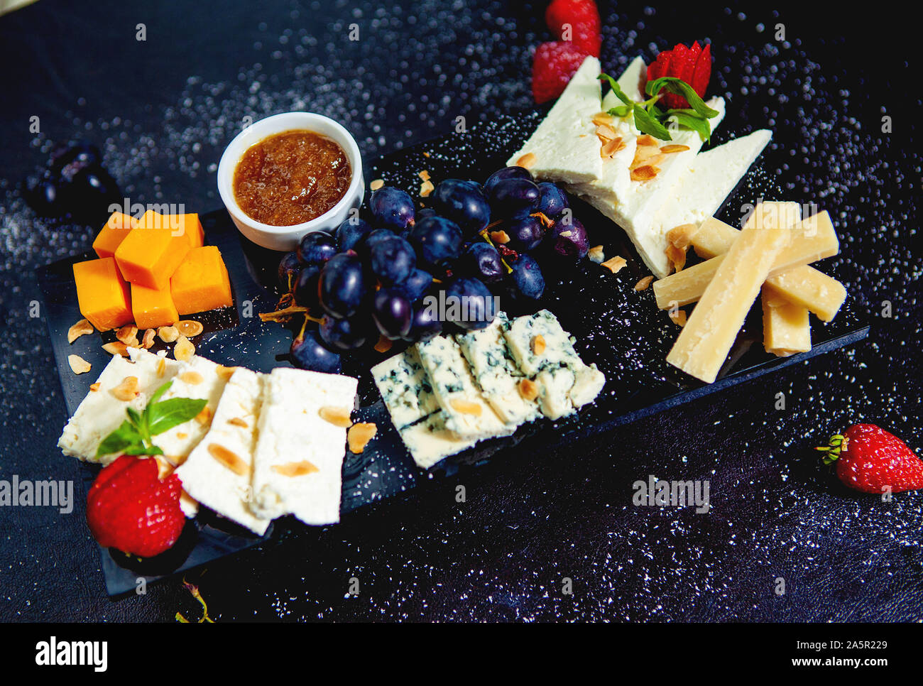 cheese plate with cheddar cubes, white cheese, parmesan sticks, blue