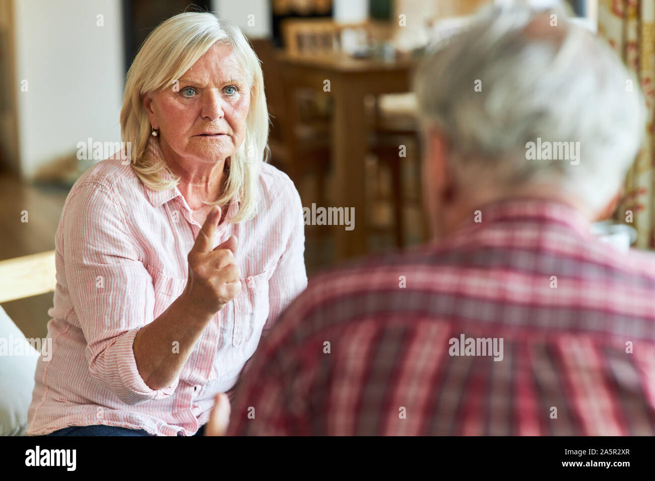 Senior couple arguing and discussing a marriage problem at home Stock Photo