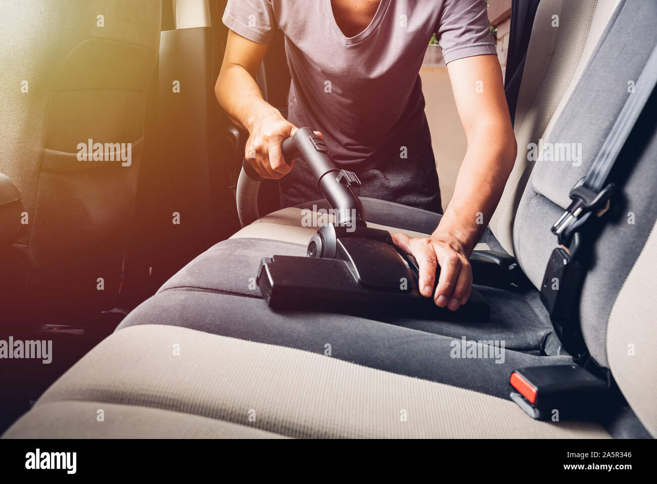 Worker man cleaning dust interior vacuum inside car Stock Photo Alamy