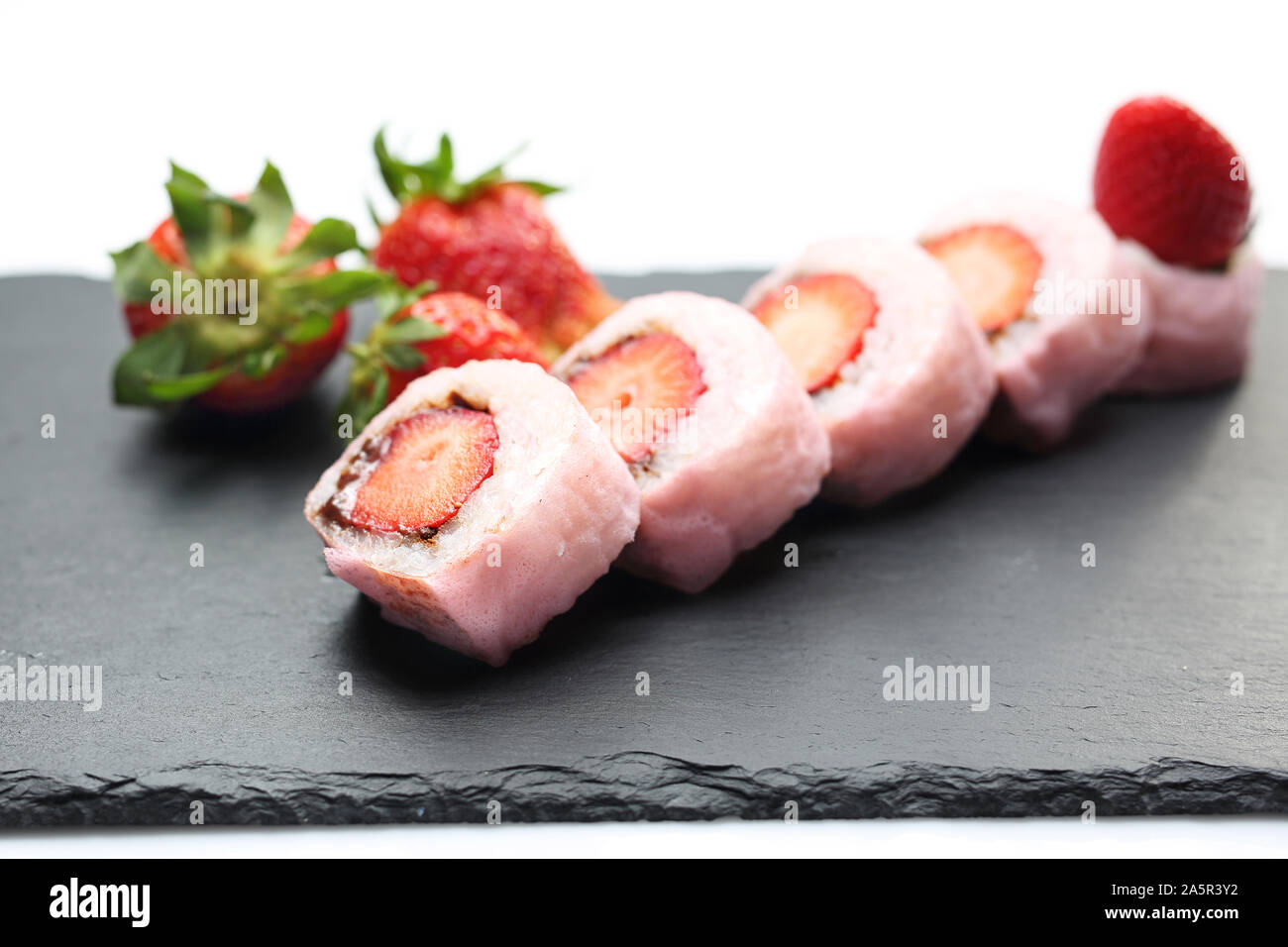 Fruit sushi, a sushi roll with strawberry and chocolate. Stock Photo