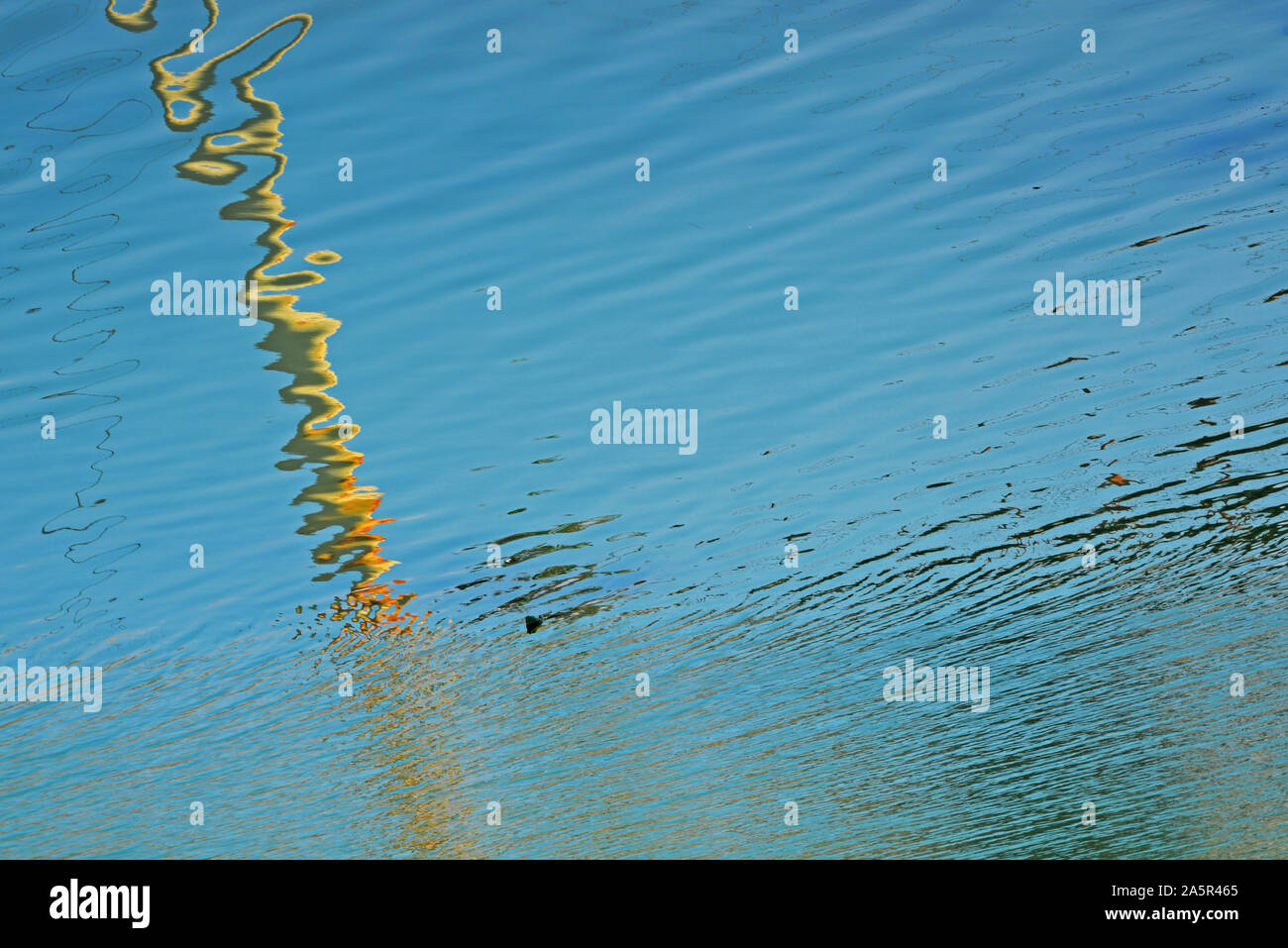 Reflection of a pillar on water. Concept: Minimalism in photography. Negative space. Stock Photo