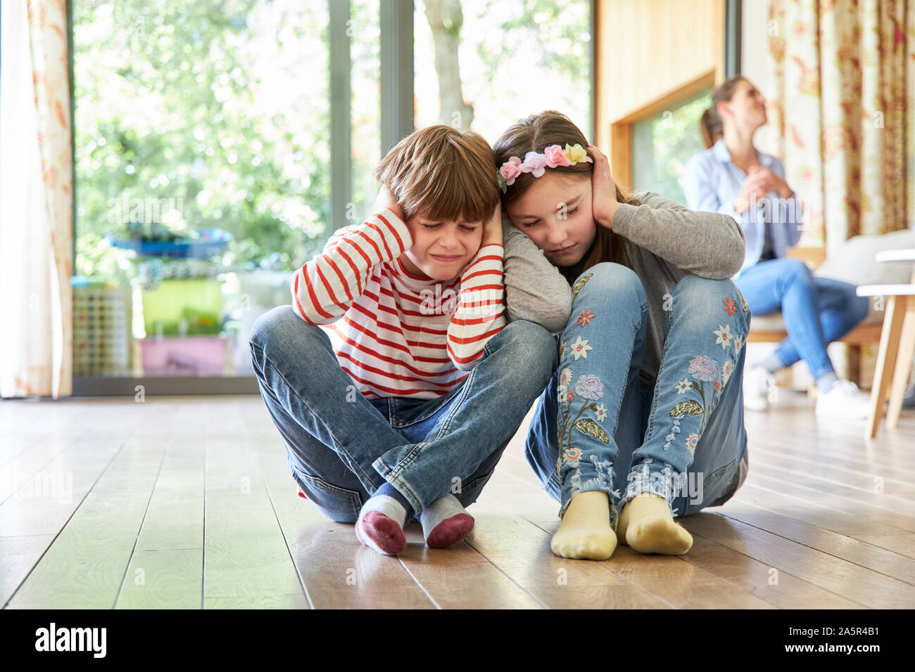 Siblings Children listen to their parents' loud argument Stock Photo