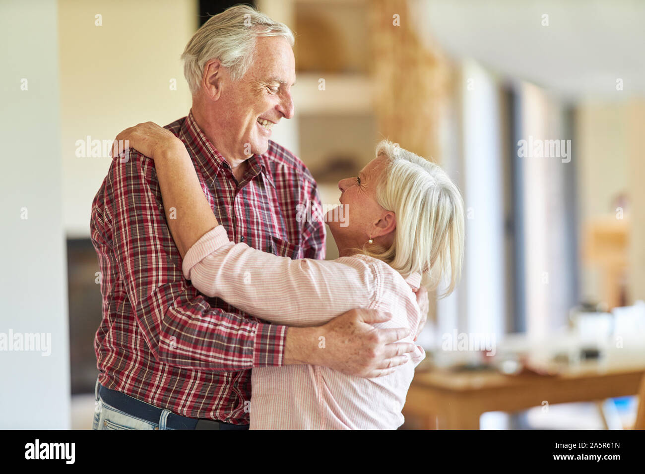 Senior couple smilingly welcomes each other while meeting or getting to know each other Stock Photo