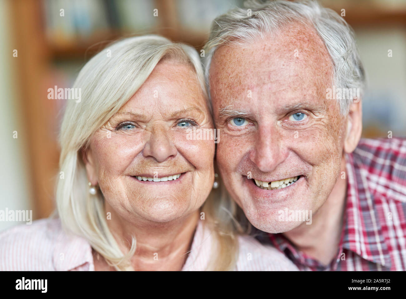 Senior couple smiling happily at the camera Stock Photo