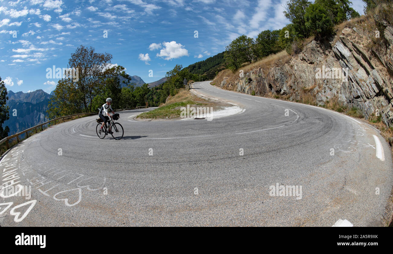 Male cyclist climbing the famous climb of Alpe d'Huez, Oisans, French Alps. Stock Photo