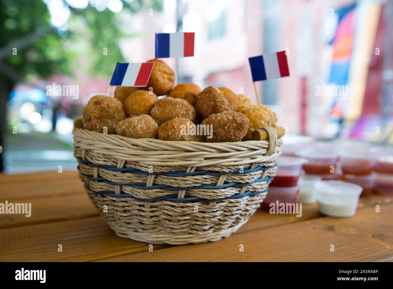 Fried mozzarella and chicken balls in a basket, fried breaded cheese snack, french cuisine, fast food. Stock Photo