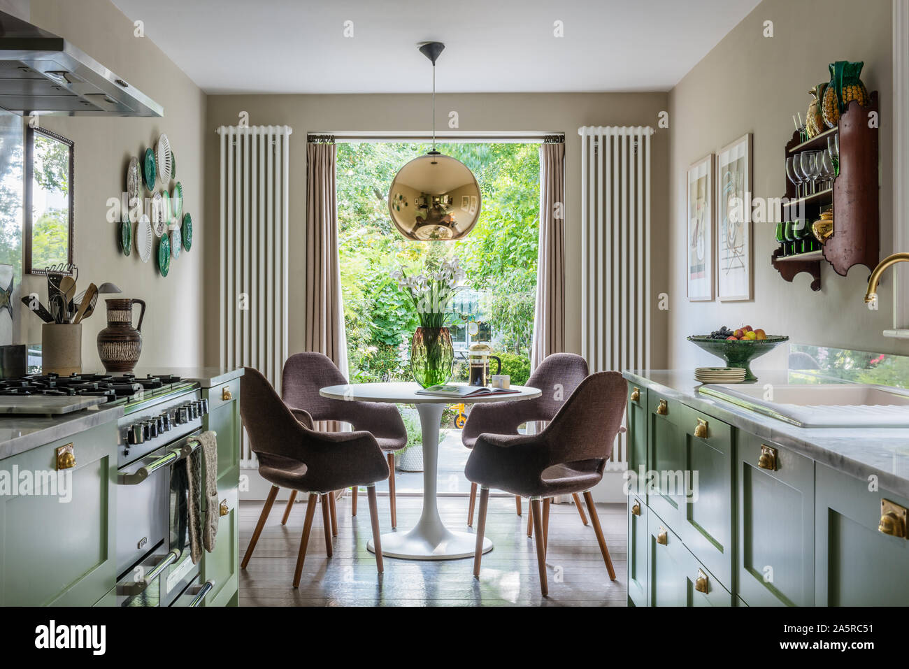 1960s seating at table in window of Victorian terrace renovation Stock Photo