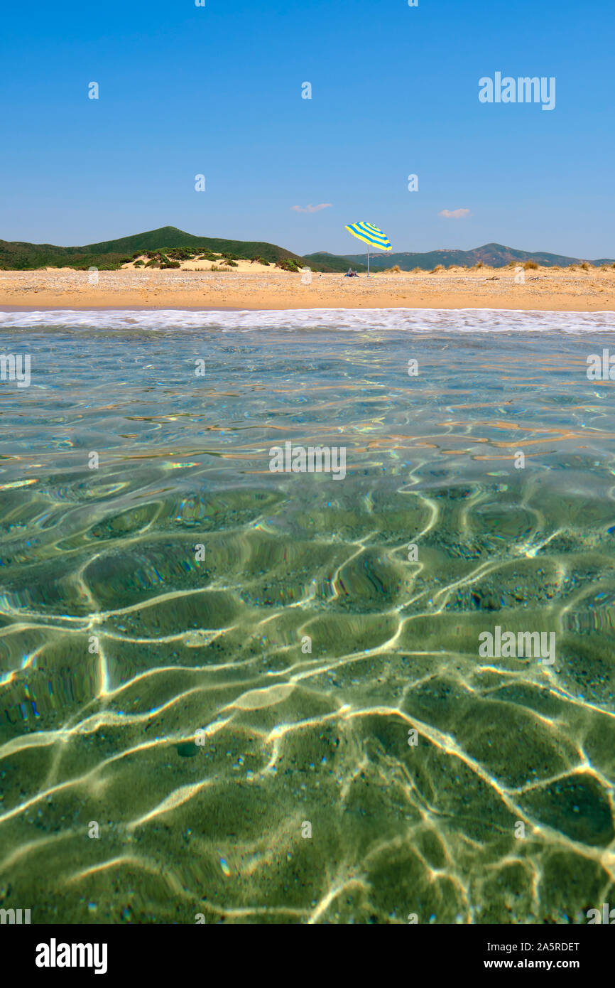 The golden sand and clear sea landscape of Spiaggia di Piscinas / Piscinas beach and the Dunes of Piscinas, Costa Verde coast Sardinia Italy Europe Stock Photo