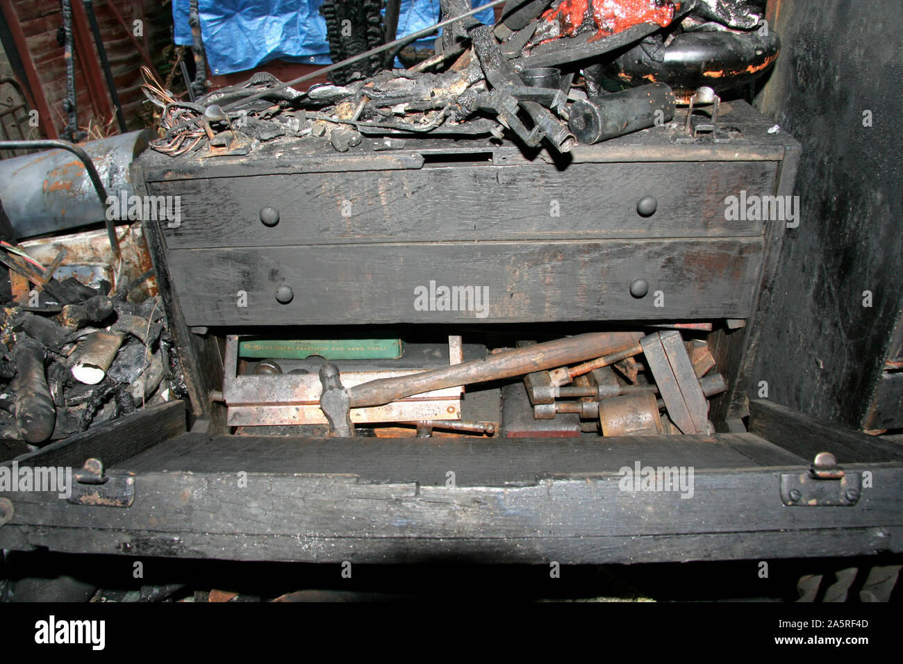 Fire Damaged Toolmakers Cabinet. Items inside it were salvageable. The fire was caused by a faulty Refridgerator Stock Photo