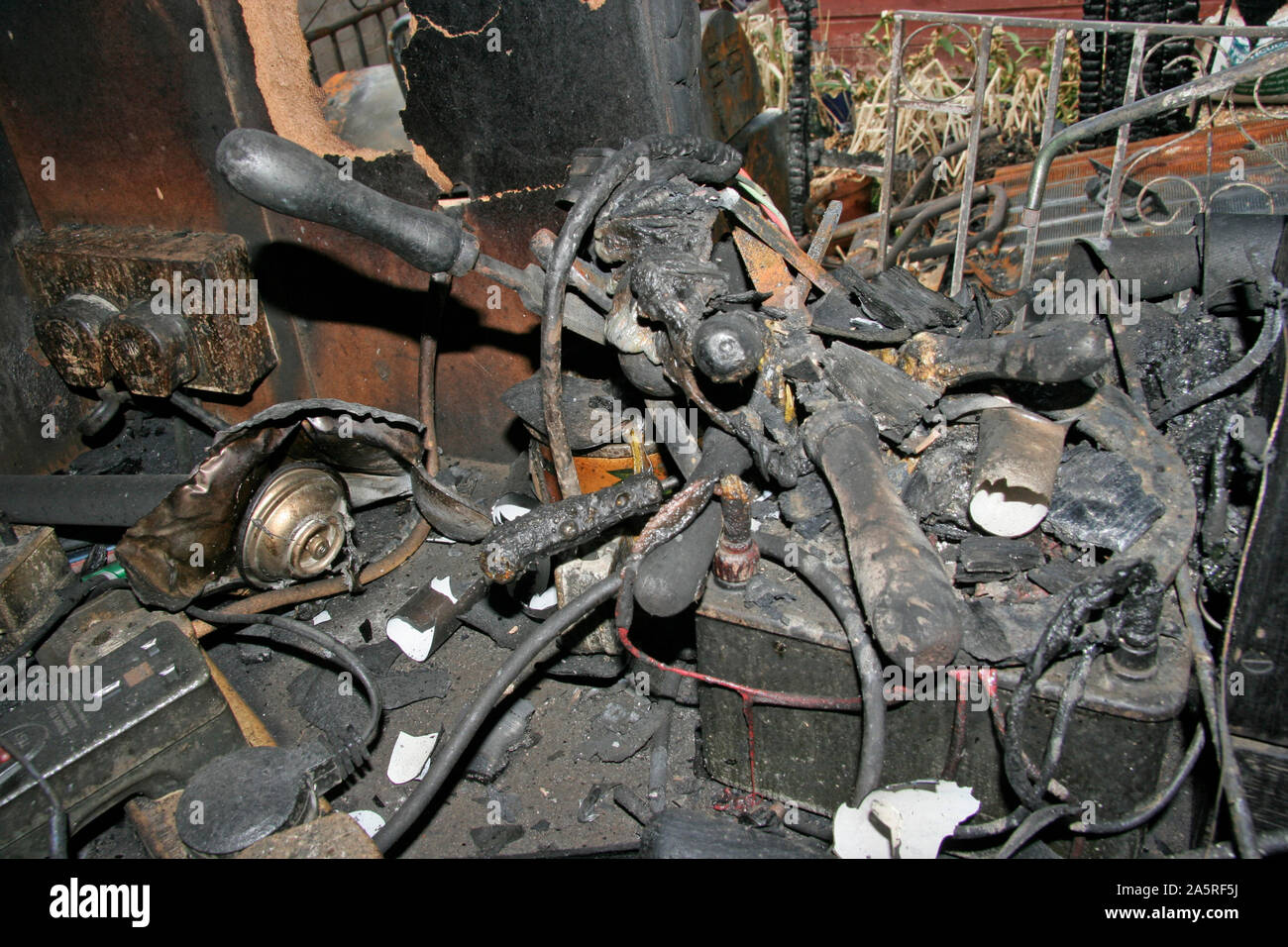 Fire Damaged items from a Garden Shed fire caused by a faulty Refridgerator Stock Photo