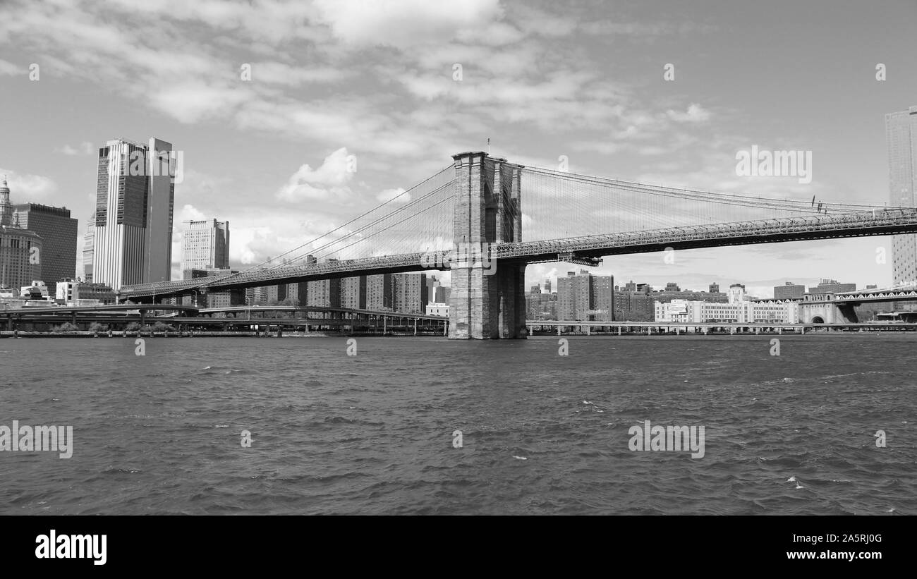 View from the East River in New York City, of the Manhattan end of the famous Brooklyn Bridge, which links the boroughs of Manhattan and Brooklyn. Stock Photo