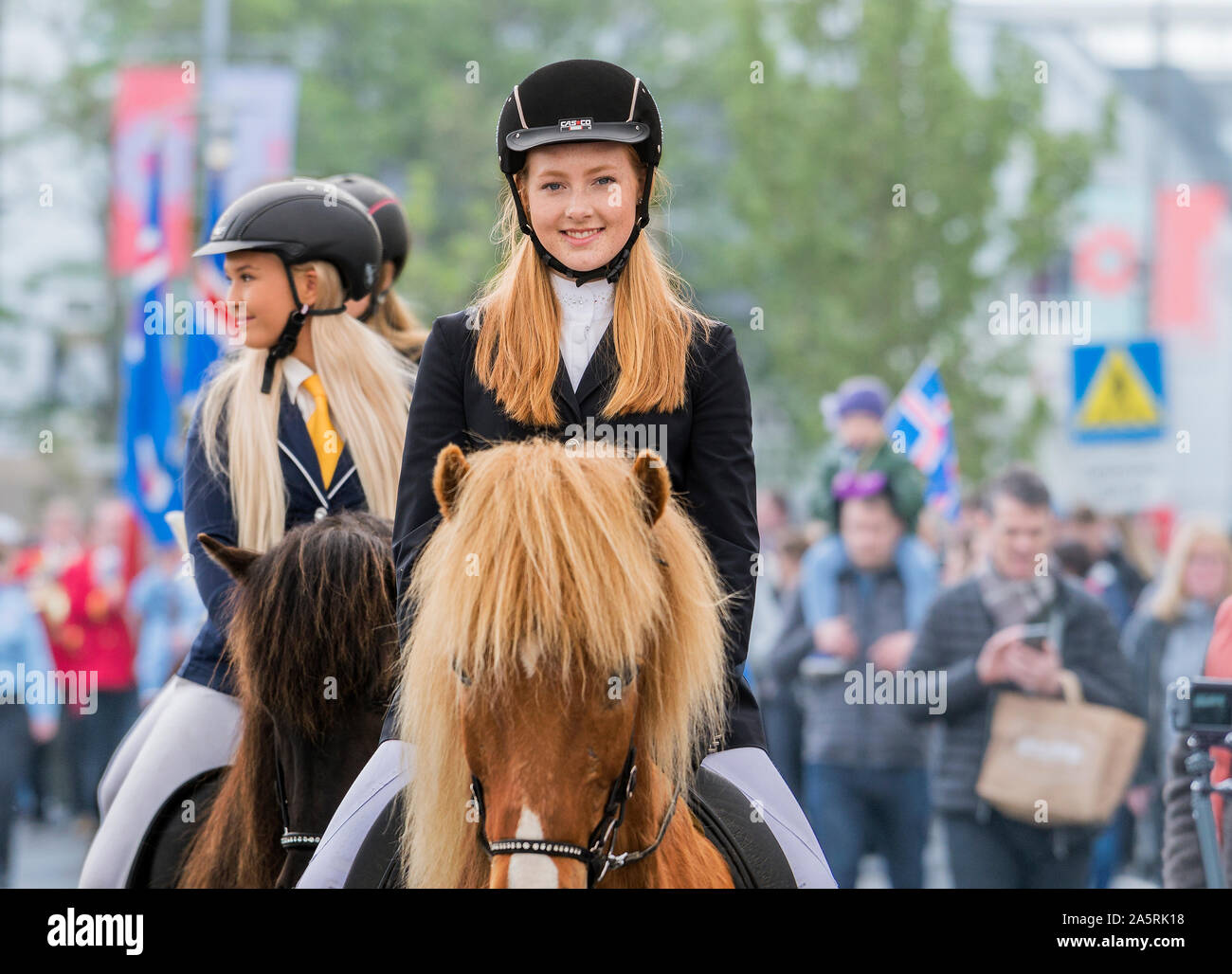 Teen girls on horseback during the independence day celebration, Reykjavik, Iceland Stock Photo