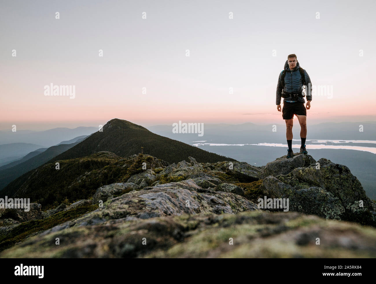 An athletic male hiker on the Appalachian Trail at sunset in Maine. Stock Photo