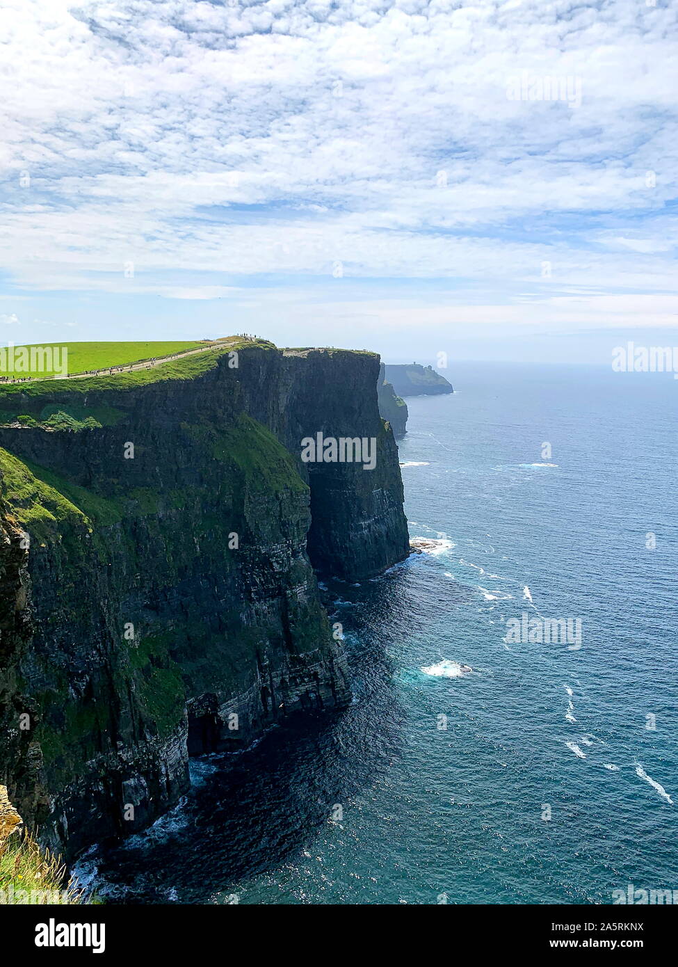 View atop the famous Cliffs of Moher overlooking the atlantic ocean Stock Photo