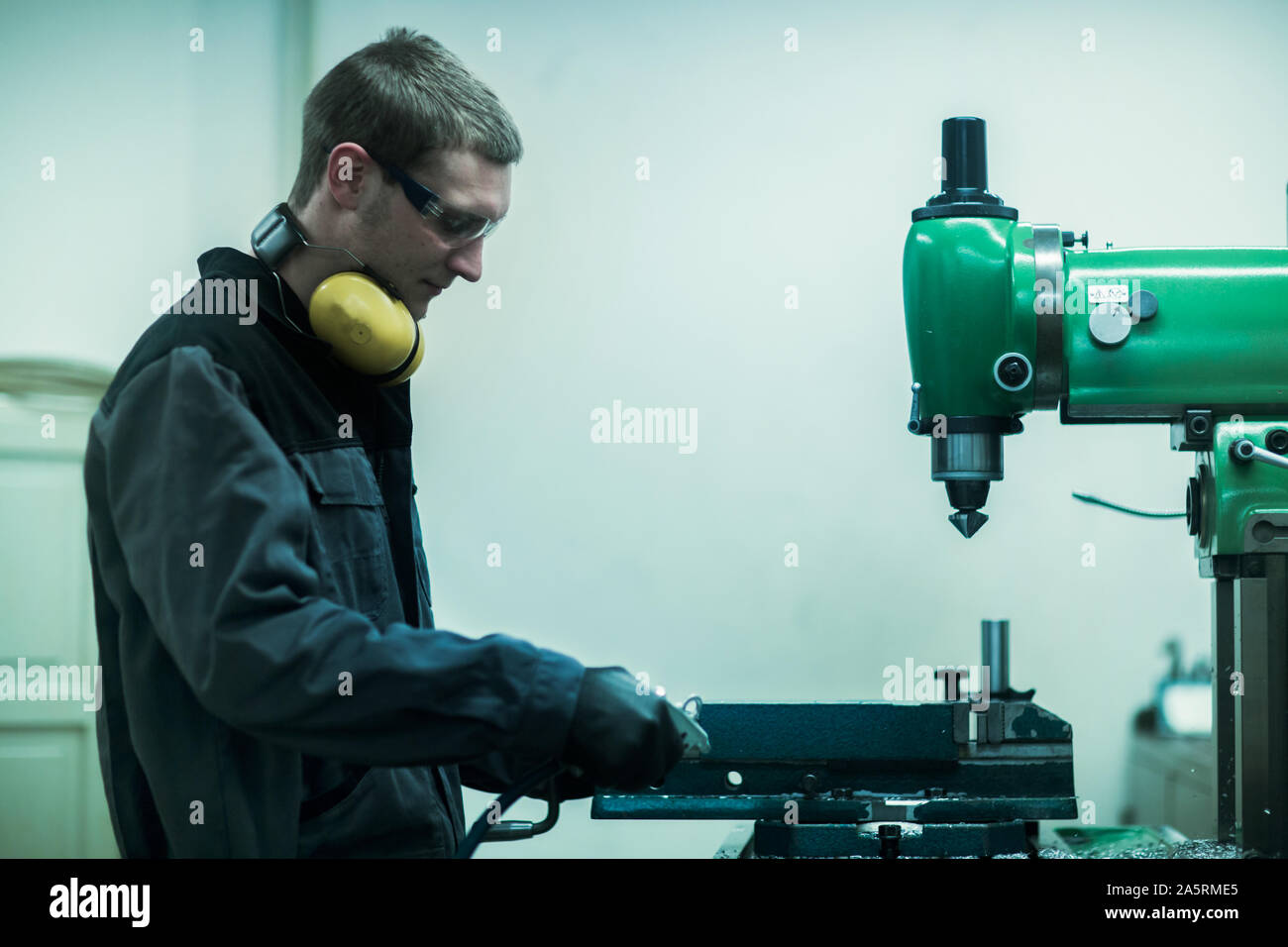 engineer in a workshop milling a tool Stock Photo