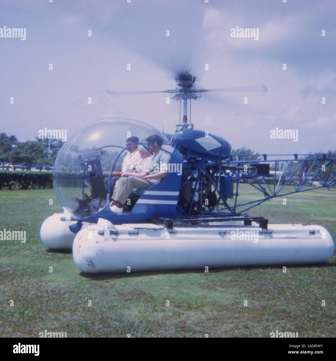 Vintage 1972 photograph, tourists in Florida on a Bell 47 helicopter with pontoons. SOURCE: ORIGINAL TRANSPARENCY Stock Photo