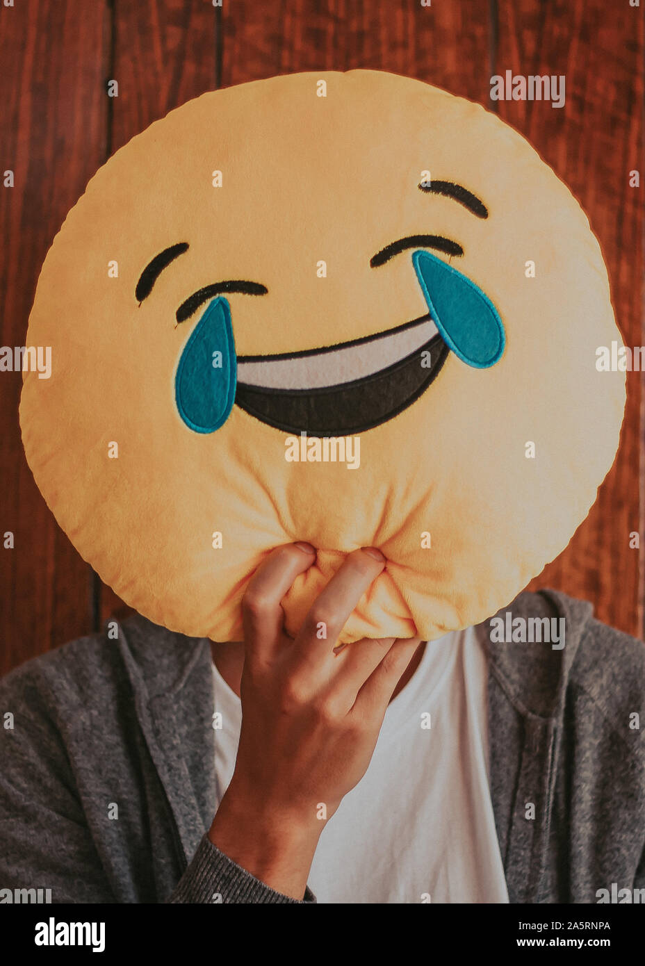 Laughter emoticon used as a mask to cover your face Stock Photo