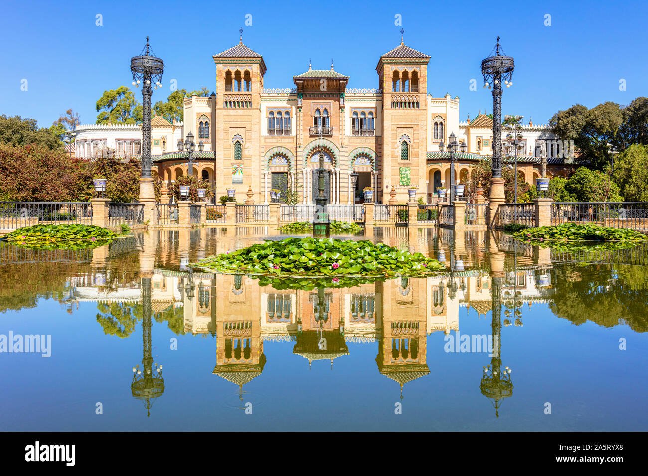 Seville Reflections in the pool opposite the Museum of Popular Arts and Traditions Seville Sevilla Seville Spain seville Andalusia Spain EU Europe Stock Photo