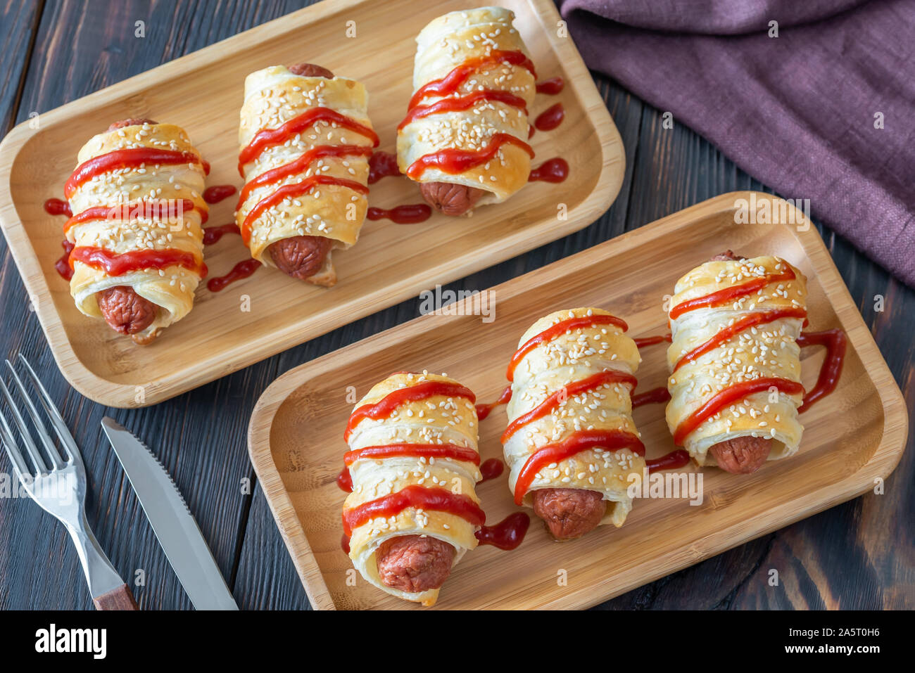 Sausage rolls on the wooden tray: top view Stock Photo