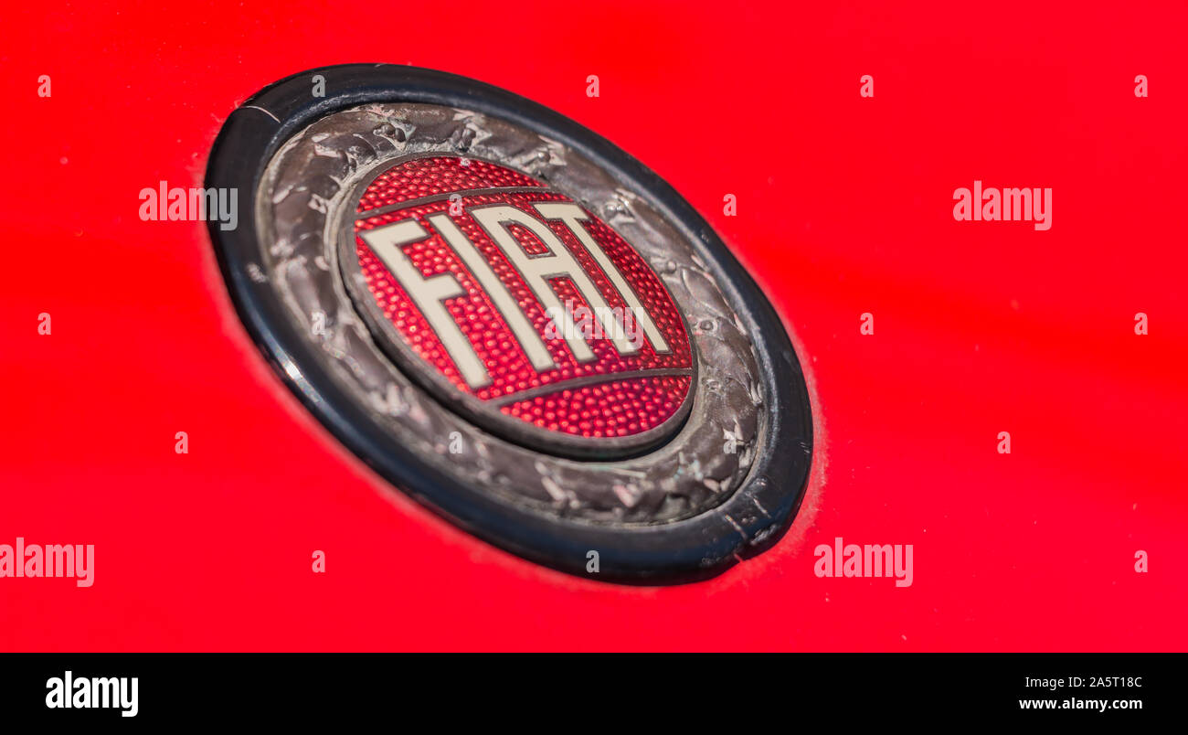 A picture of an old style Fiat logo in the front of a classic car. Stock Photo