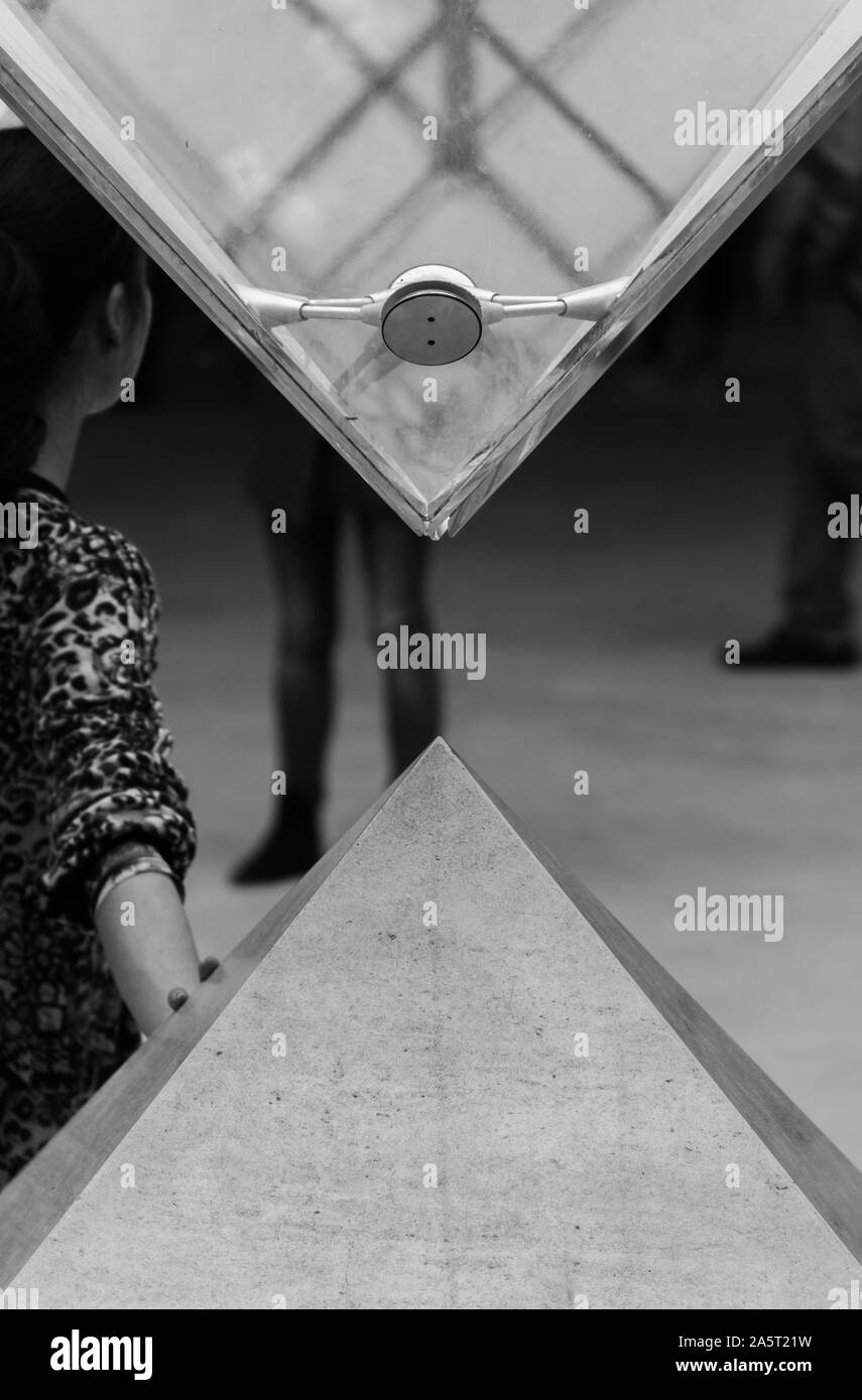 A black and white picture of the iconic pyramids inside the Louvre. Stock Photo
