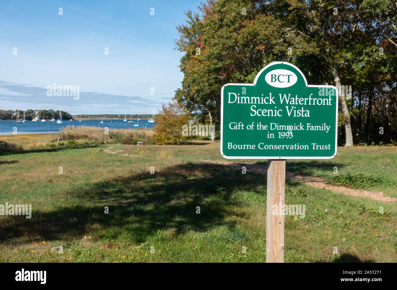 Dimmick Waterfront Scenic Vista sign for the Bourne Conservation Trust on Cape Cod with path & harbor waterfront Stock Photo