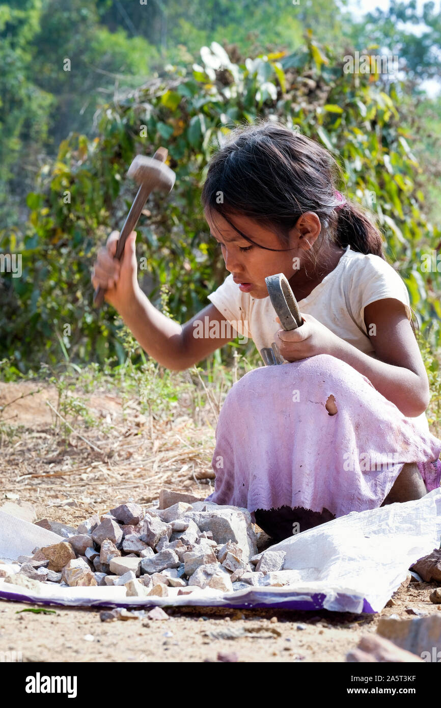 A six-year-old girl crushes stones for road construction, village Mawpat, Khasi Hills, State of Meghalaya, India, Asia Stock Photo