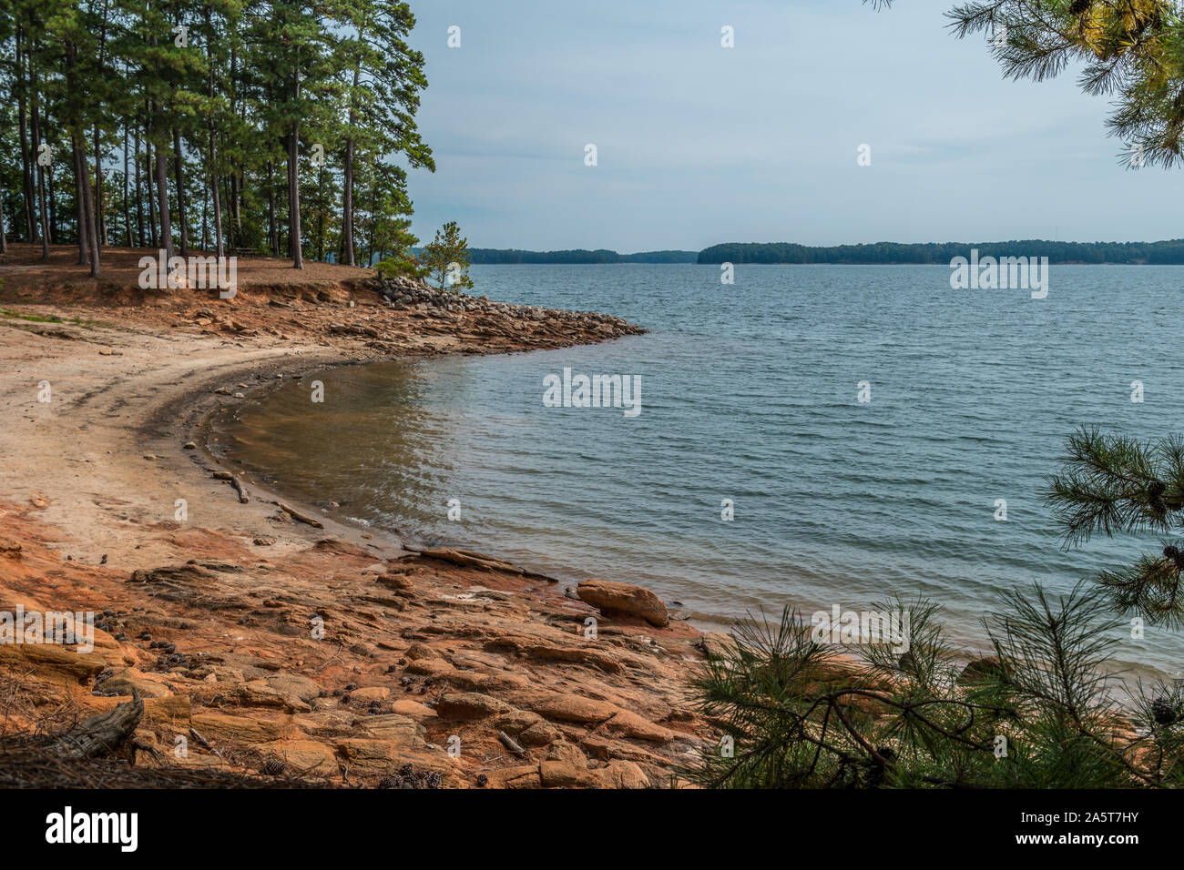 Severe drought conditions at Lake Lanier, Georgia eroding the shoreline exposing the rocks and boulders on a sunny day in fall Stock Photo