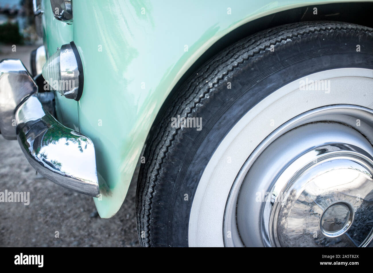 Whitewall tire mounted on restored 60s car. Closeup Stock Photo