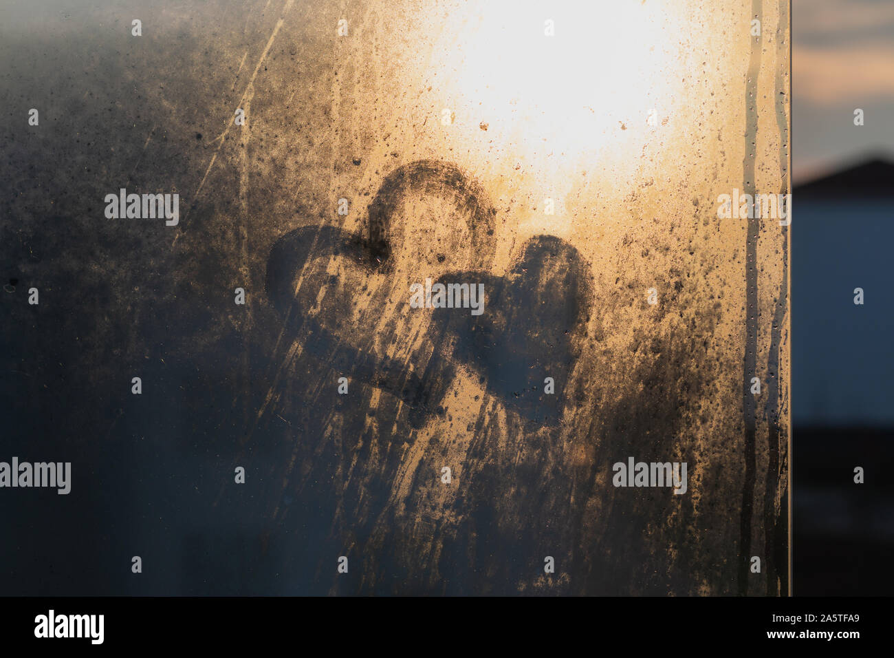 Two hearts drawn on foggy window at morning Stock Photo