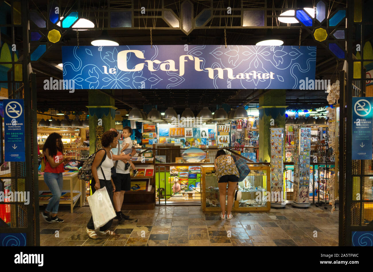 tourists shopping for gifts and souvenirs; Le Craft Market, Port Louis Mauritius Stock Photo
