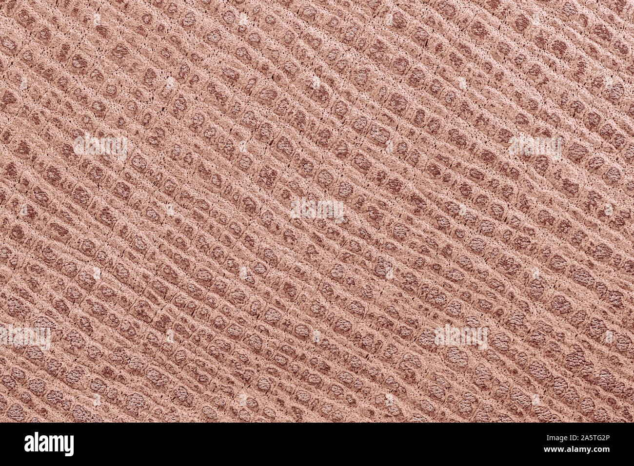 Texture of genuine grainy leather close-up, color of porous milk chocolate. Fashionable modern background, copy space Stock Photo