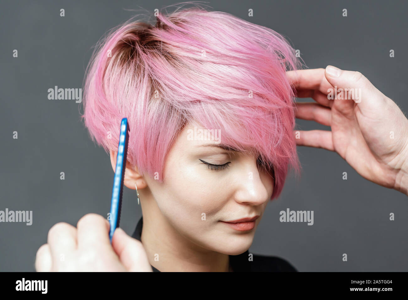 Hands of hairdresser checks short pink hair of girl on gray background close up. Hairdresser checks with comb short pink hairstyle of young woman Stock Photo - Alamy Hands of hairdresser checks short pink hair of girl on gray background close up. Hairdresser checks with comb short pink hairstyle of young woman Stock Photo - Alamy