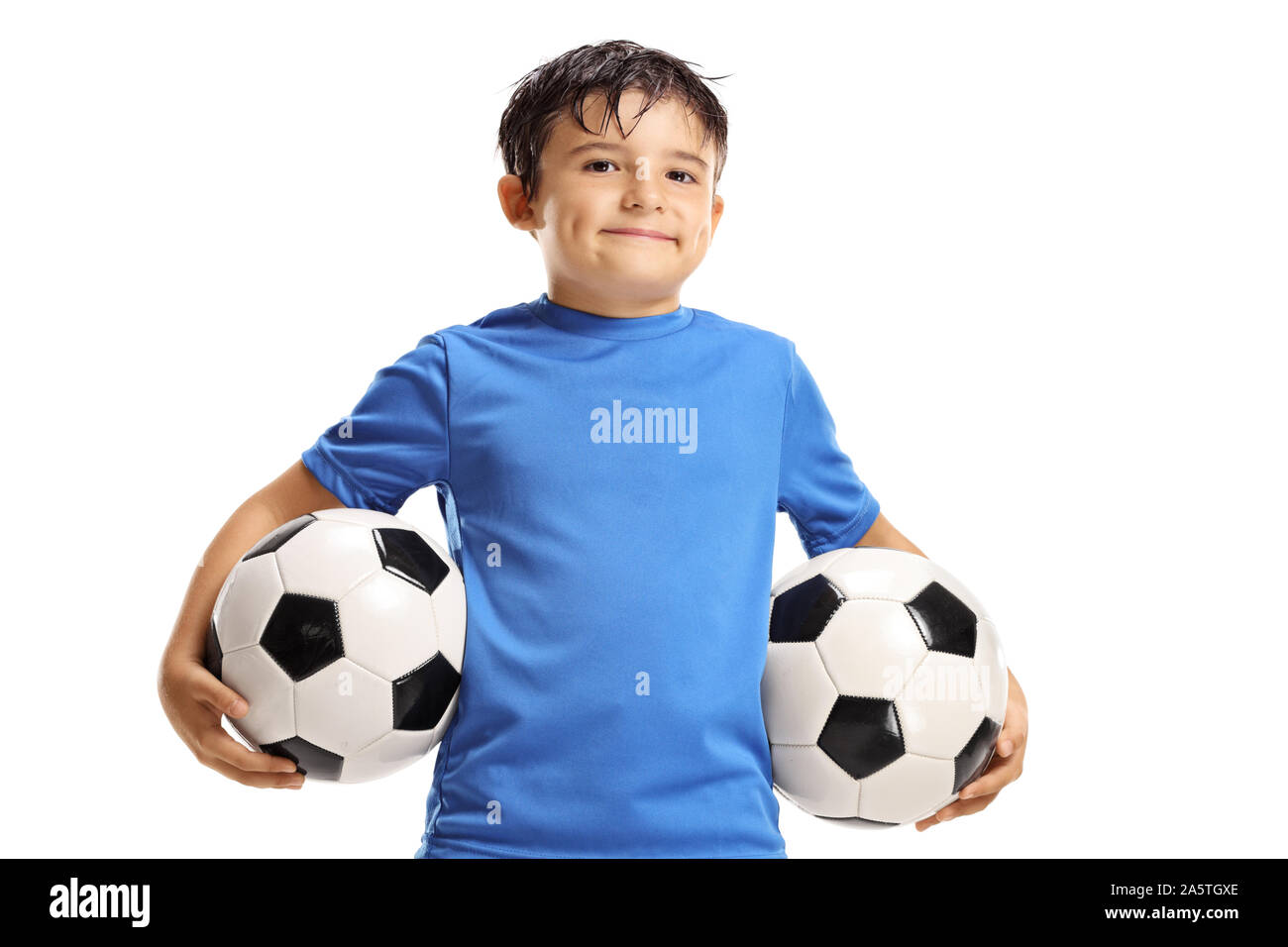 Boy holding two soccer balls isolated on white background Stock Photo