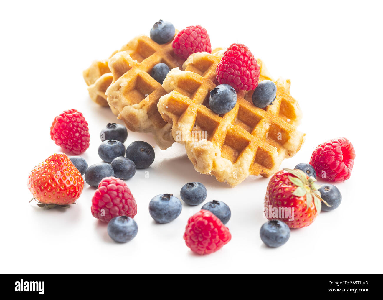 Waffles with blueberries and raspberries isolated on white background. Stock Photo
