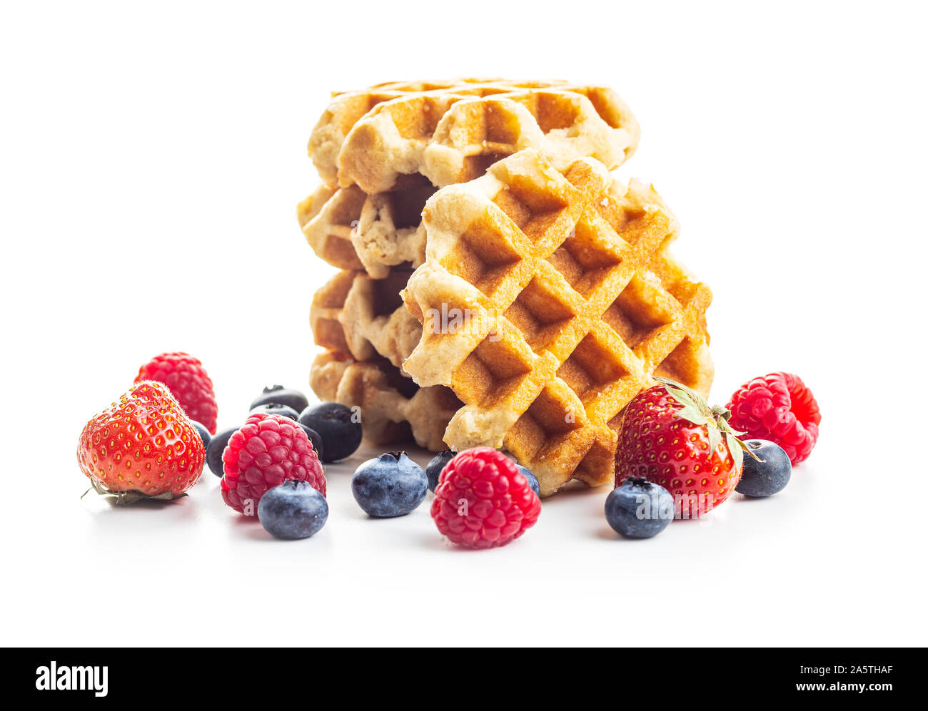 Waffles with blueberries and raspberries isolated on white background. Stock Photo