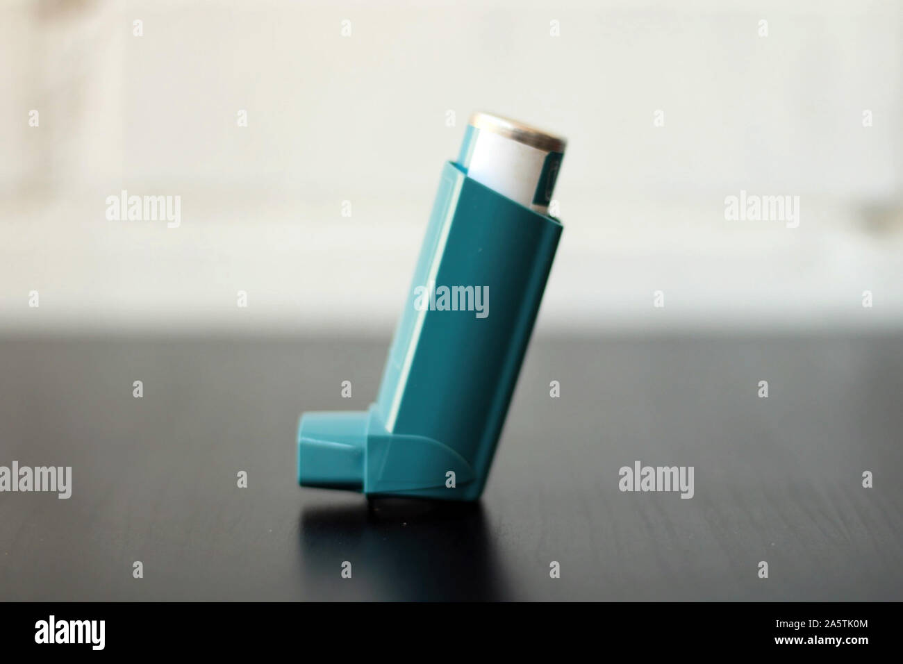 Medicine and health concept Blue inhaler. Pharmaceutical product for