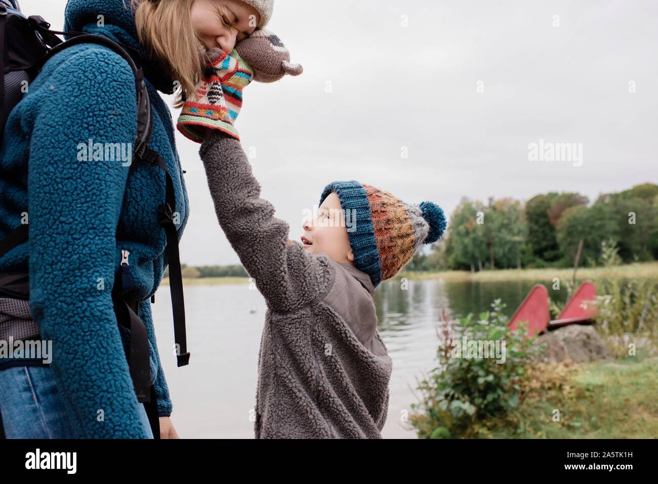mother and son playing together laughing outside whilst camping Stock
