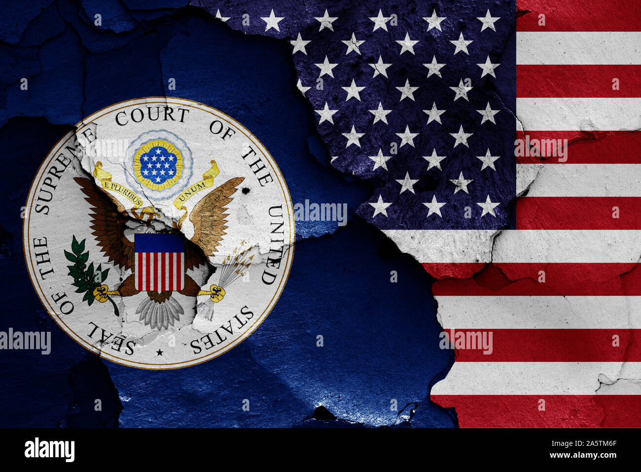 flags of Supreme Court of the United States and USA painted on cracked wall Stock Photo
