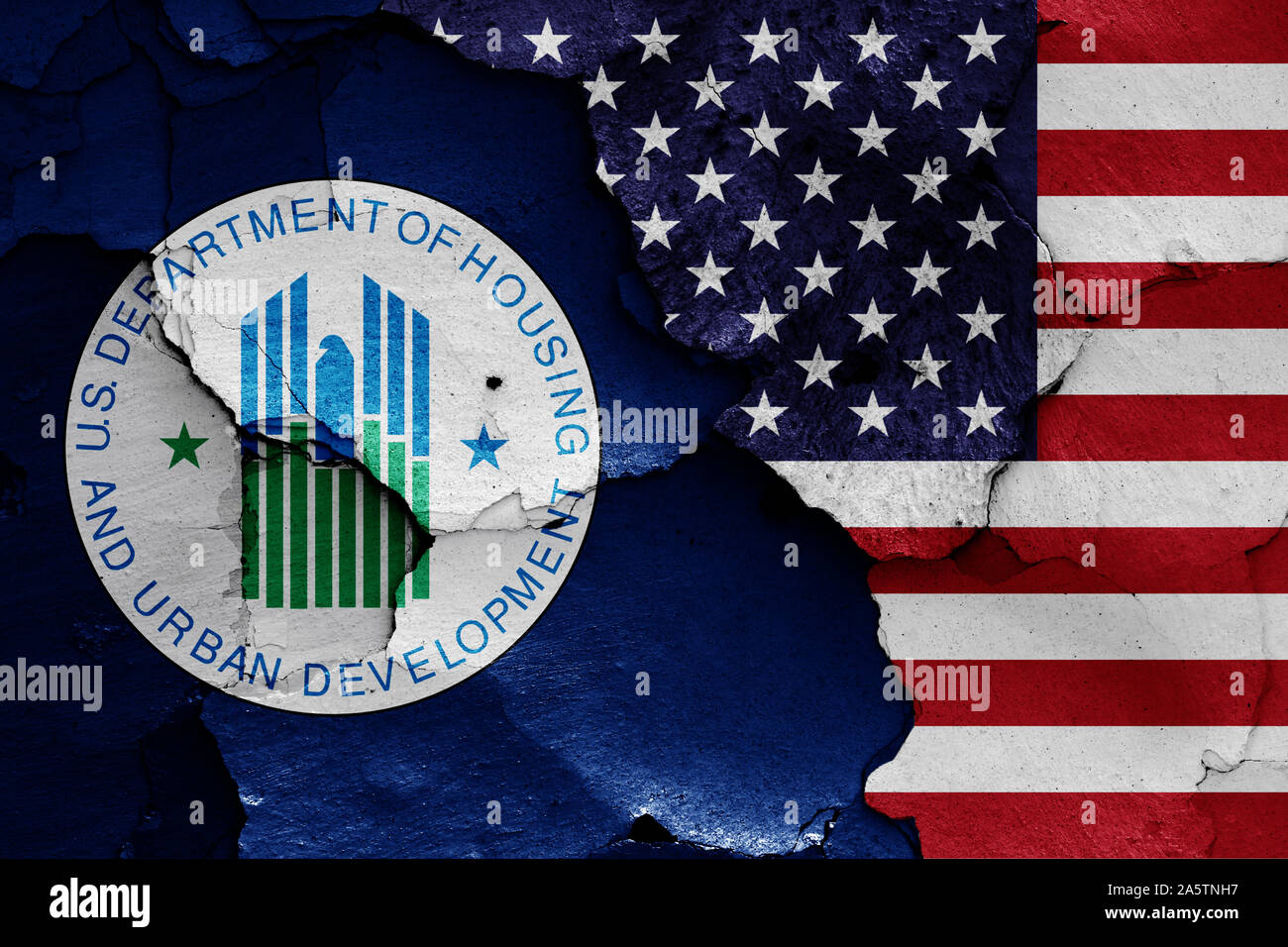 flags of Department of Housing and Urban Development and USA painted on cracked wall Stock Photo