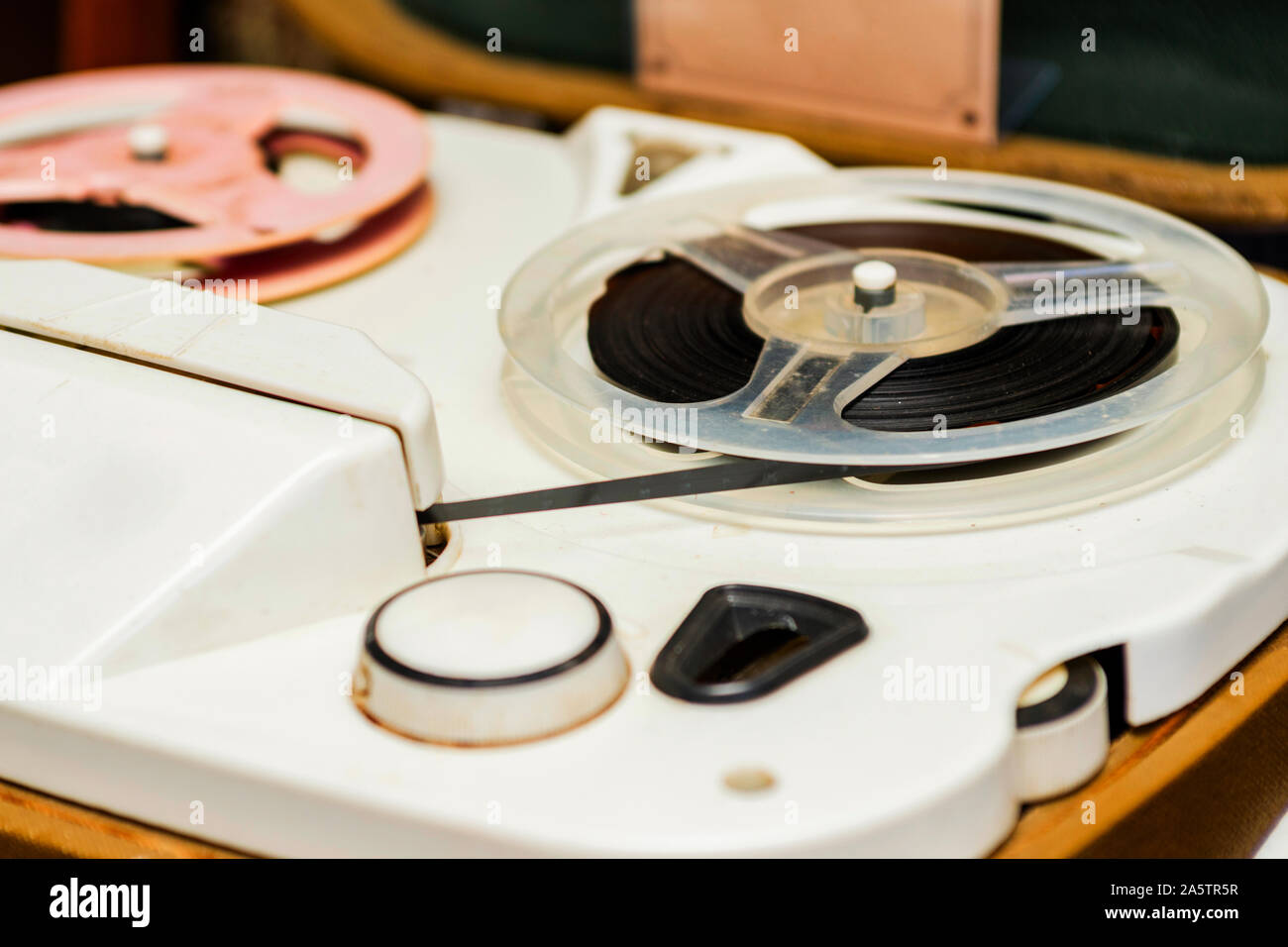Vintage tape recorder is playing music, close up. Vintage tape recorder roller Stock Photo