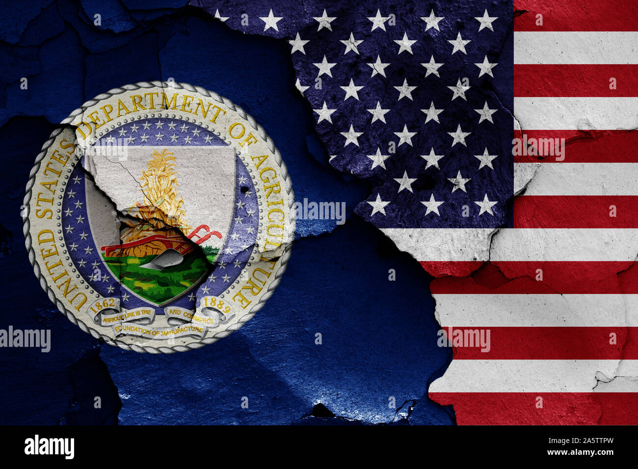 flags of Department of Agriculture and USA painted on cracked wall Stock Photo