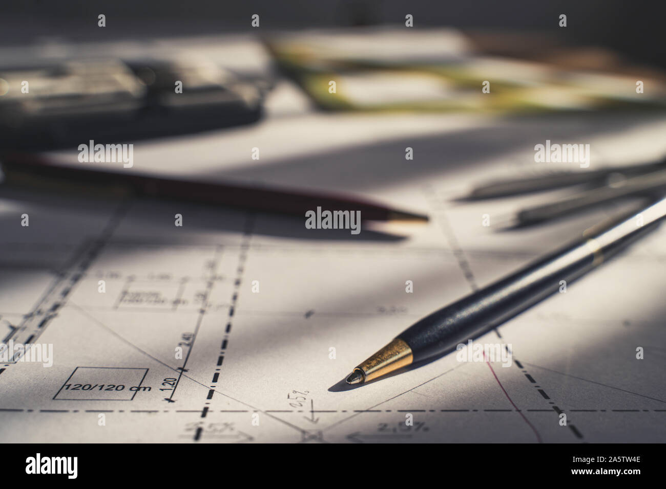 Architect design. Sketch, plans blueprints. Pencil, dividers, ruler. Sunlight on the blueprint. Architecture concept. Stock Photo
