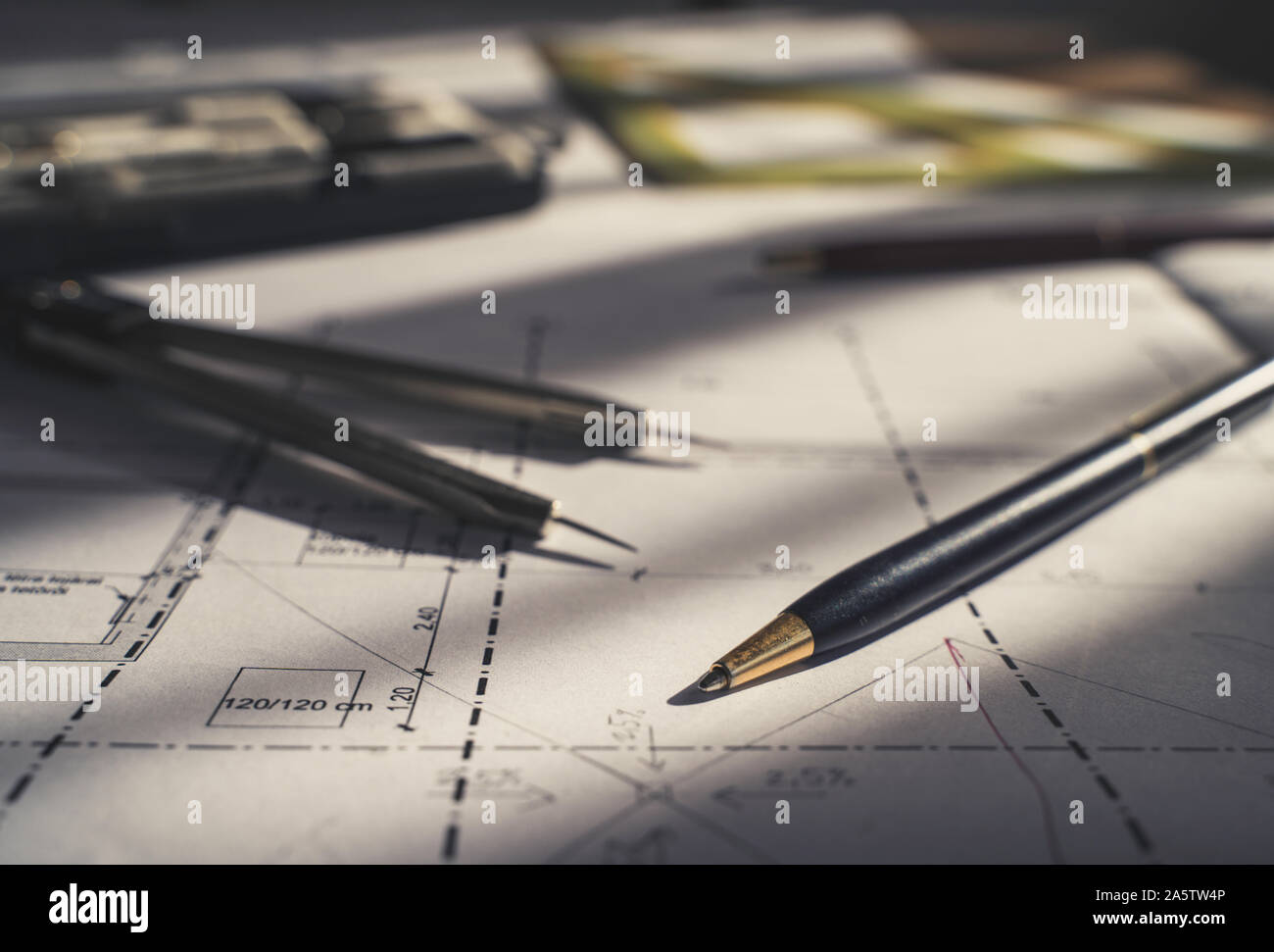 Architect design. Sketch, plans blueprints. Pencil, dividers, ruler. Sunlight on the blueprint. Architecture concept. Stock Photo