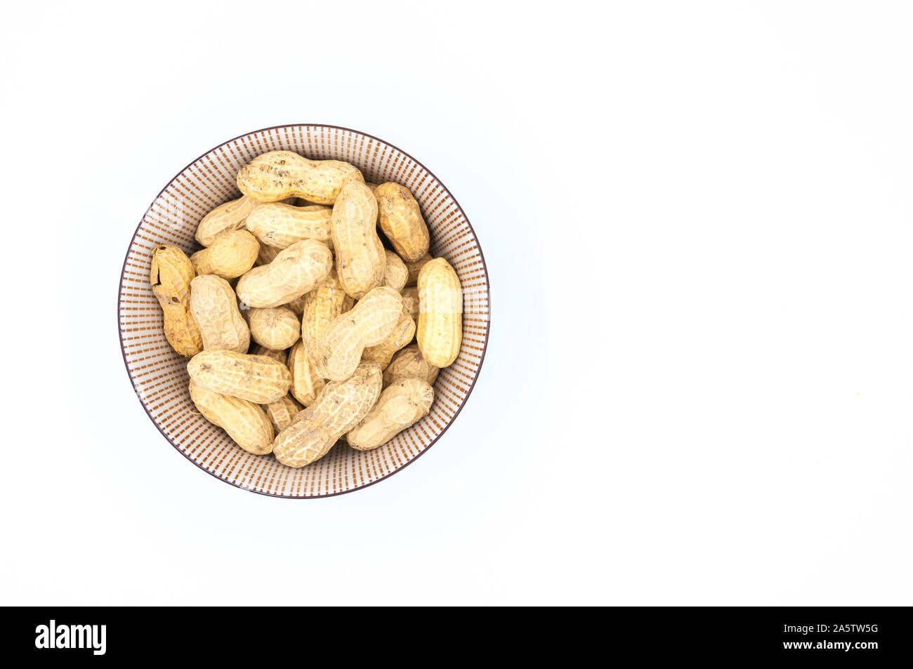 peanuts in shells in a bowl isolated on white background Stock Photo