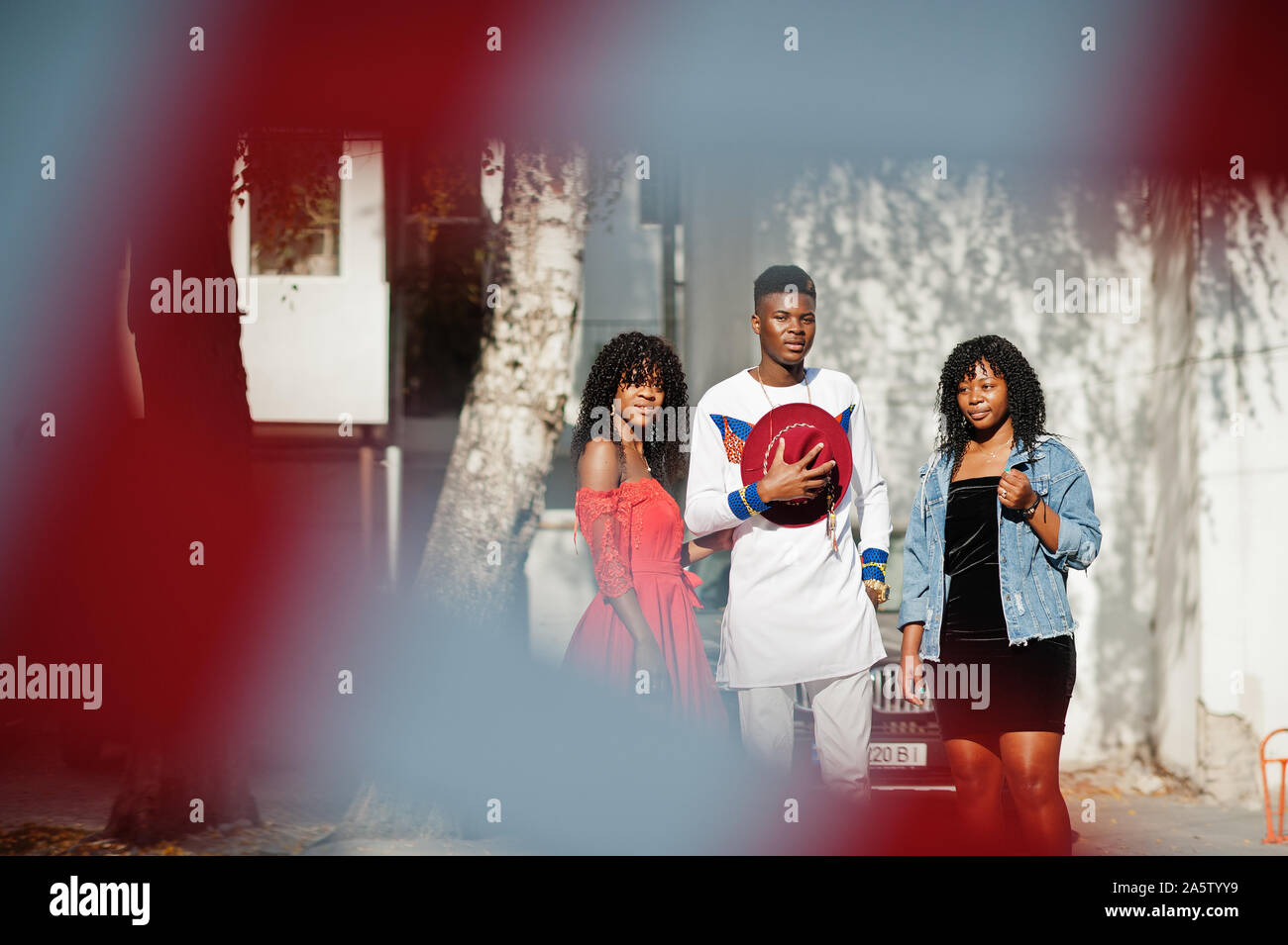Group of three stylish trendy afro france friends posed at autumn